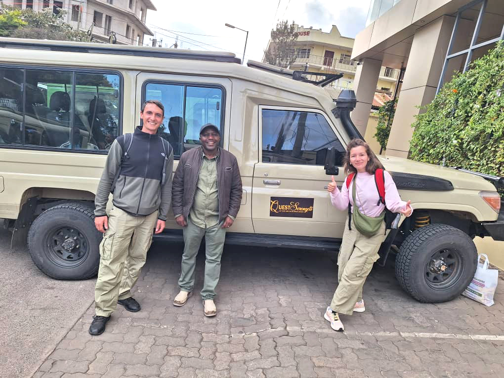 Quest Serengeti Safaris guests with safari vehicle